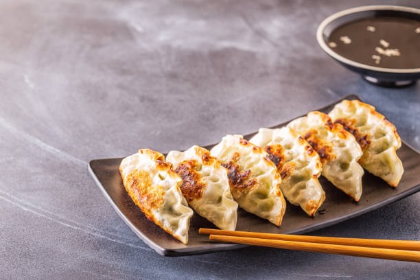 istock Gyoza or dumplings snack with soy sauce, selective focus 1128055668