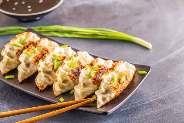 istock Gyoza or dumplings snack with soy sauce, selective focus 1128055677