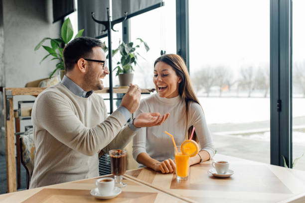 istock Young sweet couple at cafe. 1128055680