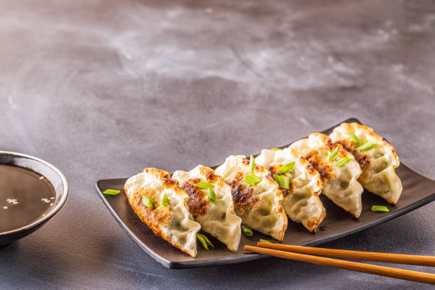 istock Gyoza or dumplings snack with soy sauce, selective focus 1128055687