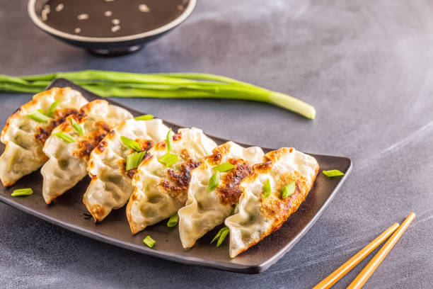istock Gyoza or dumplings snack with soy sauce, selective focus 1128055689