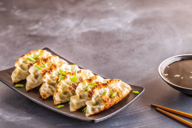 istock Gyoza or dumplings snack with soy sauce, selective focus 1128055694