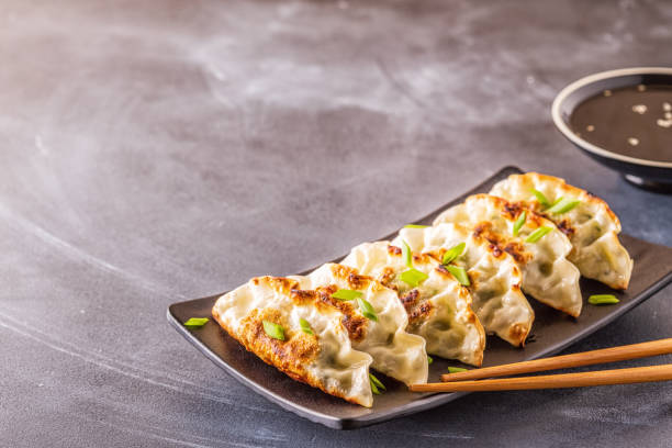 istock Gyoza or dumplings snack with soy sauce, selective focus 1128055730