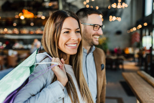 Young couple in shopping Shopping time. Young couple in shopping. Consumerism, love, dating, lifestyle concept holiday shopping stock pictures, royalty-free photos & images