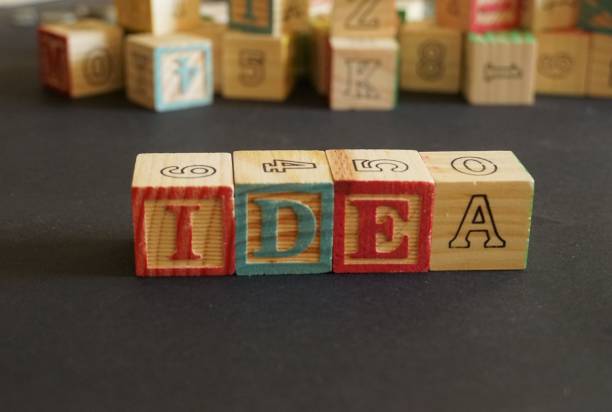 istock Word Idea written using wooden cubes on black background 1128056175