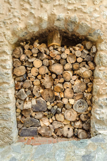 istock Firewood stacked in a yellow wall niche 1128057611