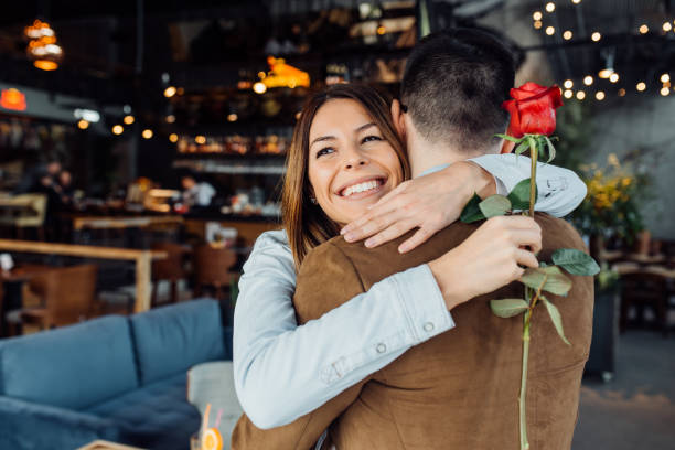 istock Happy young couple with red rose 1128057686