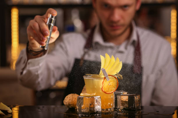 istock Barmen making alcohol cocktail. Fresh alcohol Penicillin cocktail with orange slice and ice cubes 1128058221
