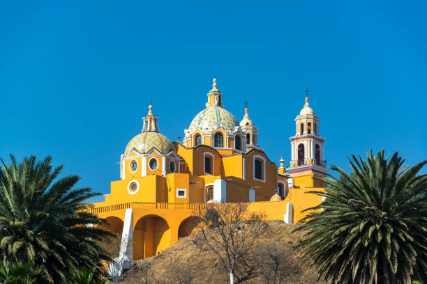 Yellow Church and Palm Trees Stunning Our Lady of Remedies church and palm trees in Cholula, Mexico popocatepetl volcano photos stock pictures, royalty-free photos & images