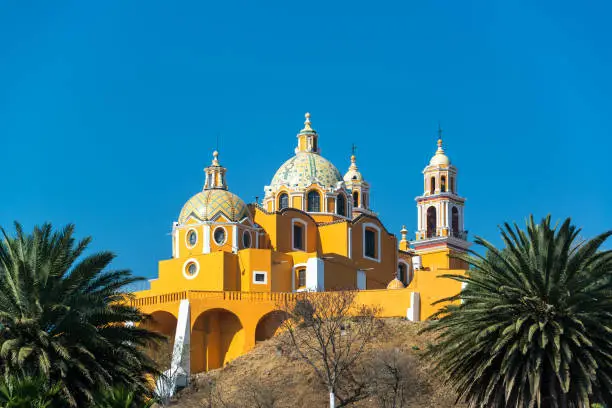 Stunning Our Lady of Remedies church and palm trees in Cholula, Mexico