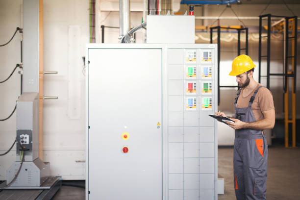istock Young maintenance technician checking machines in factory 1128059050