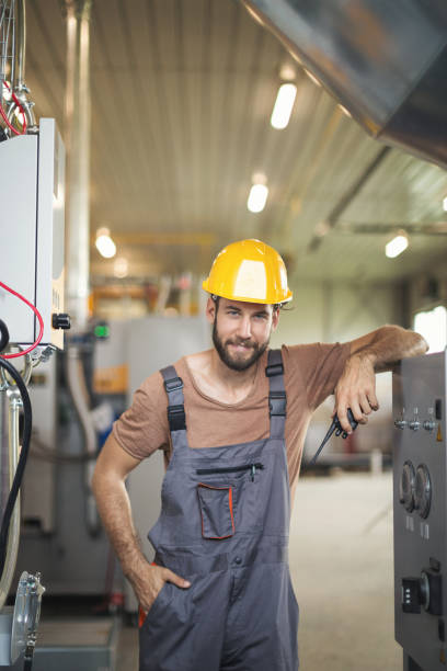 istock Young maintenance technician checking machines in factory 1128059596