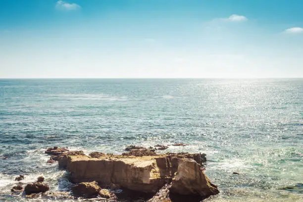 Minimalistic landscape of Laguna Beach in California view on pacific ocean water and rock