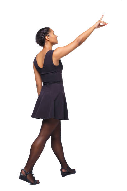 istock Back view of walking young black girl. 1128062285