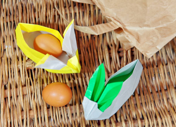 istock Handicraft origami rabbits from paper. Easter bunnies. Creative package for gift 1128064587