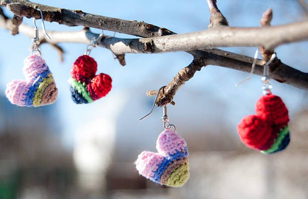 crochet hearts hanging on a branch stock photo