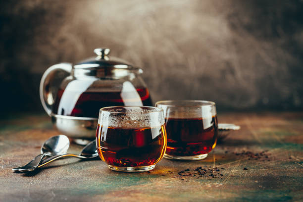 istock Transparent glass teapot black tea and glass cups 1128065508