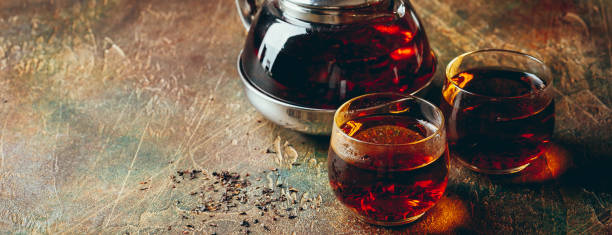 istock Transparent glass teapot black tea and glass cups 1128065520
