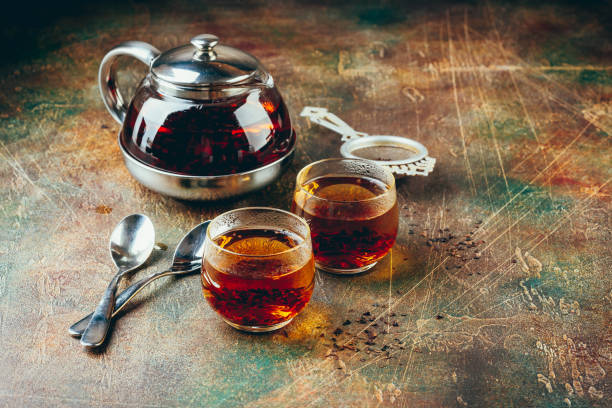 istock Transparent glass teapot black tea and glass cups 1128065530