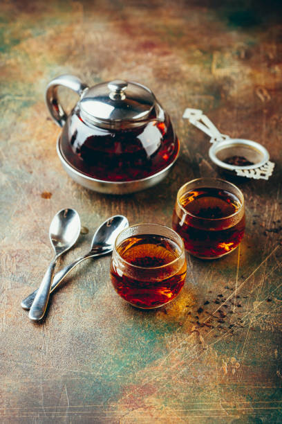 istock Transparent glass teapot black tea and glass cups 1128065534