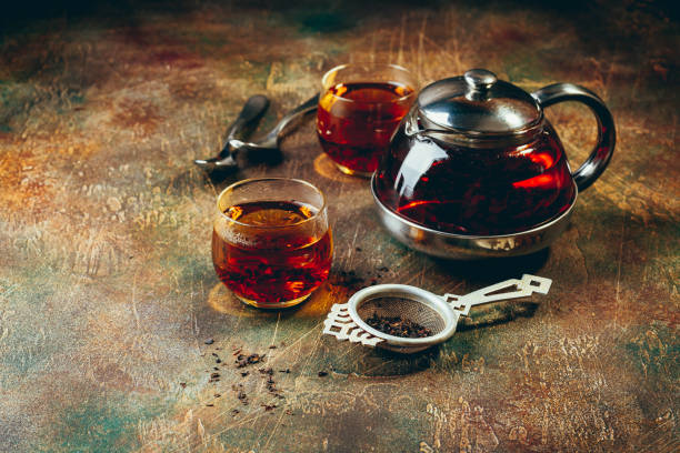 istock Transparent glass teapot black tea and glass cups 1128065535