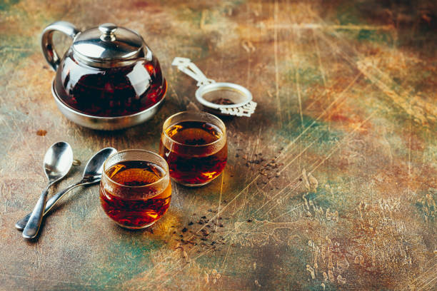 istock Transparent glass teapot black tea and glass cups 1128065544