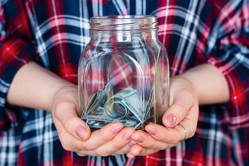 girl holding a jar for donations, fundraising, charity