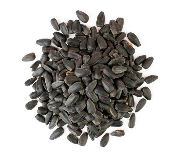 istock Heap sunflower seeds on a white. The view from the top. 1128070808