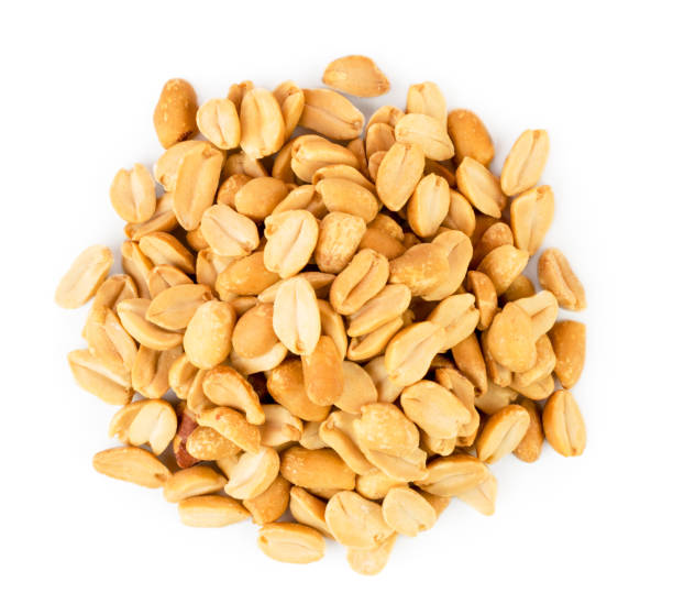 istock Heap roasted peanuts close up on a white. Isolated. 1128070809