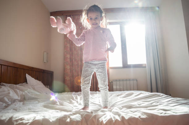 istock Beautiful girl jumping on the bed 1128071016