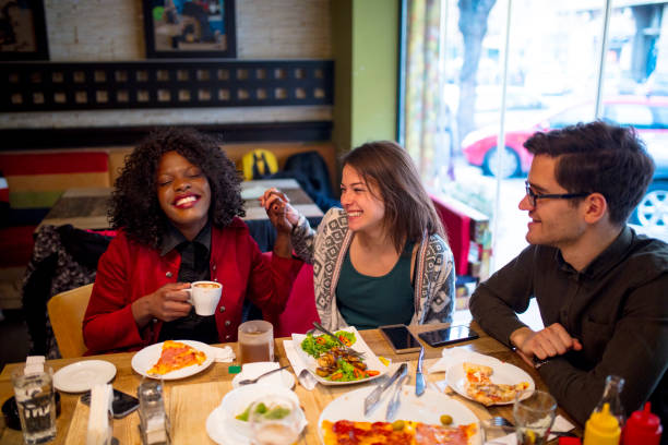 istock Friends Enjoying In Restaurant 1128071039