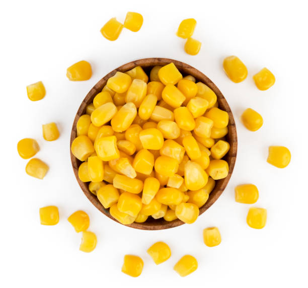 istock Corn in a tin can and scattered on a white. The view from the top. 1128071823