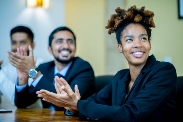 istock Business professionals applauding at a conference table 1128073104