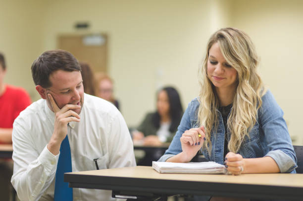 istock University teacher walking around his classroom and talking with students 1128073871