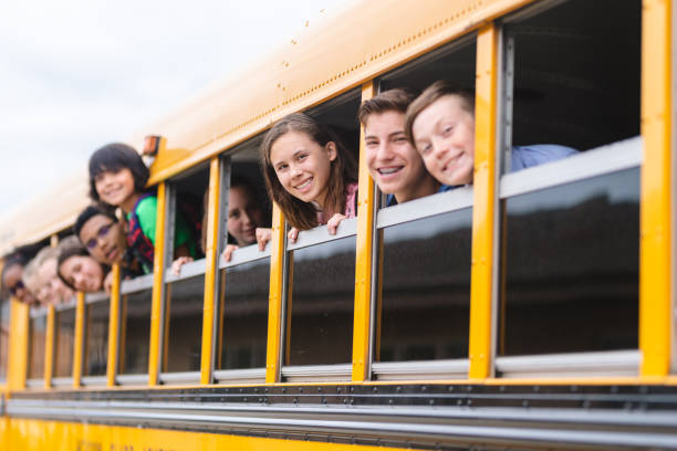 istock Portrait of elementary students in school bus 1128074004