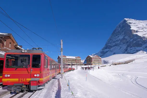 Photo of Jungfrau railway train station at Kleine Scheidegg to Jungfraujoch, north face of mount Eiger in background, Switzerland