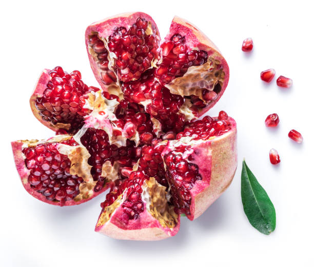 istock Opened ripe pomegranate fruit on the white background. 1128076713