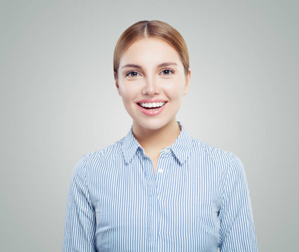 istock Cute young woman student smiling on white background 1128076842