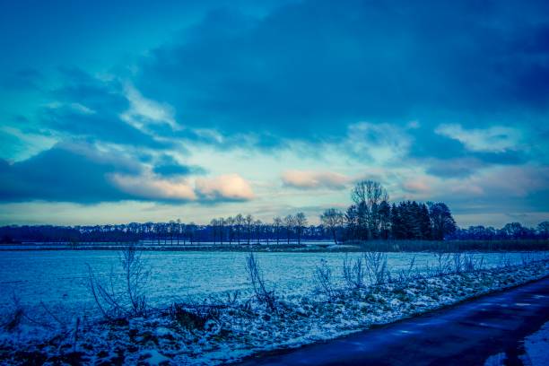 istock Field in winter next to a road 1128076930