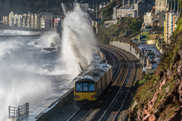 istock Local train and storm waves just past Dawlish station 1128078087