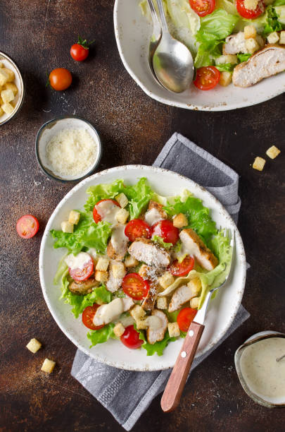 istock Caesar salad with chicken, tomatoes, Parmesan and croutons 1128080129