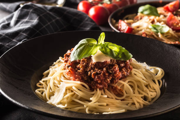 istock Close up italian spaghetti bolognese in black plate 1128081886