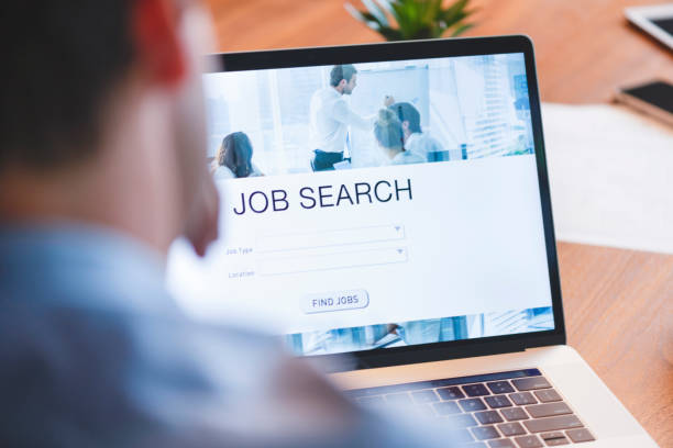 istock Businessman looking at job search website on a laptop computer. 1128082128