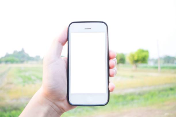 istock Cropped Hand Holding Mobile Phone In City 1128082654