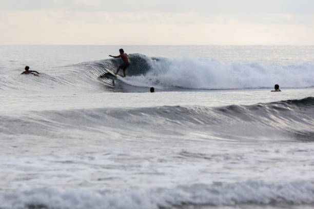 istock Man Surfing In Sea Against Sky 1128082769