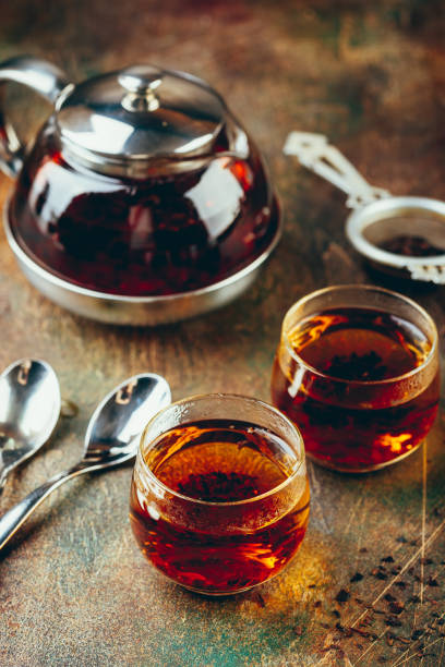istock Transparent glass teapot black tea and glass cups 1128084628