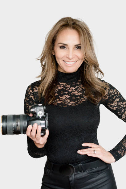 istock Mature woman photographer with camera 1128085395