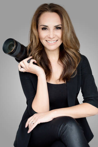 istock Mature woman photographer with camera 1128085407