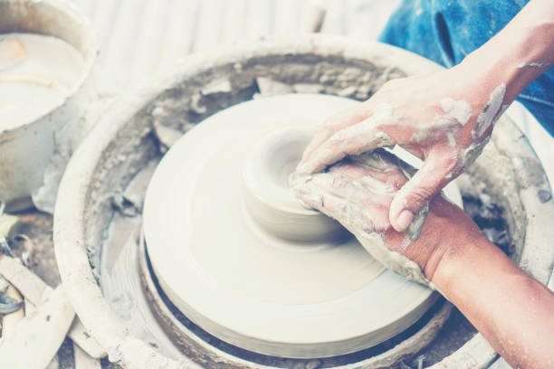 istock Cropped Hands Of Man Making Pot Outdoors 1128086713