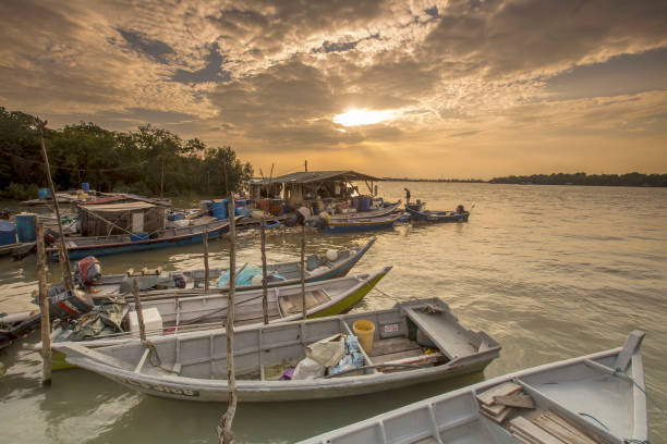 istock Rowboats Moored In Sea Against Sky During Sunset 1128086994